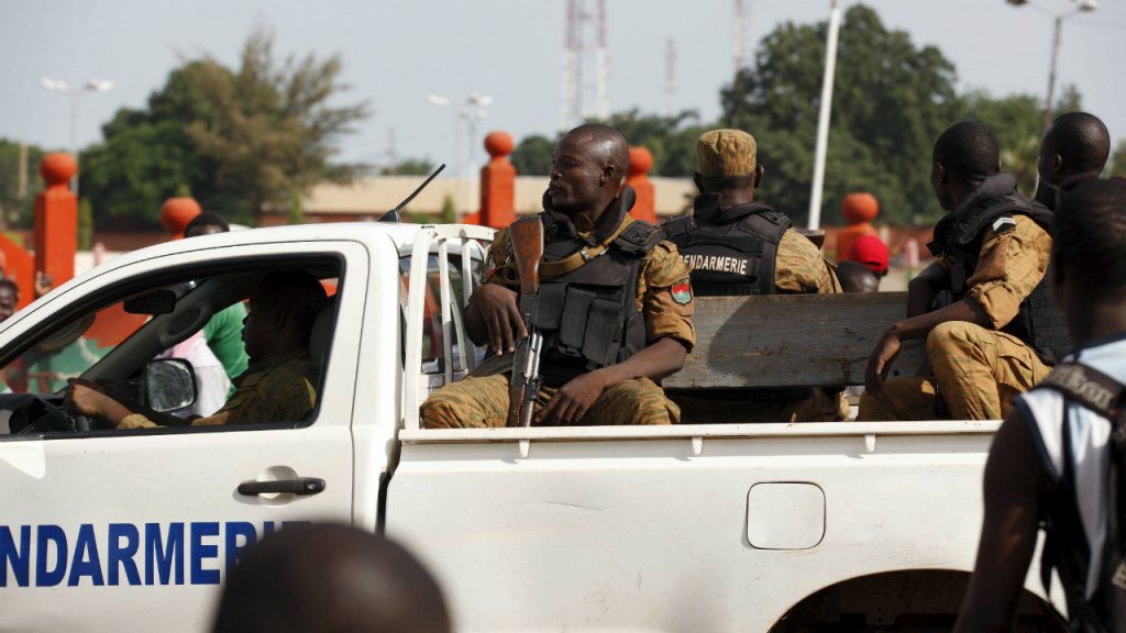Joe Penny, Reuters | Gendarmes drive by anti-coup protesters in Ouagadougou, Burkina Faso, September 22, 2015.