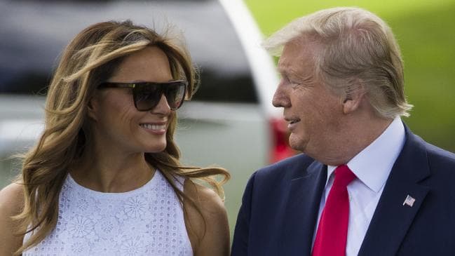 President Donald Trump, accompanied by First Lady Melania Trump, smiles as he walks to speak with the media before boarding Marine One at the White House. Picture: APSource:AP