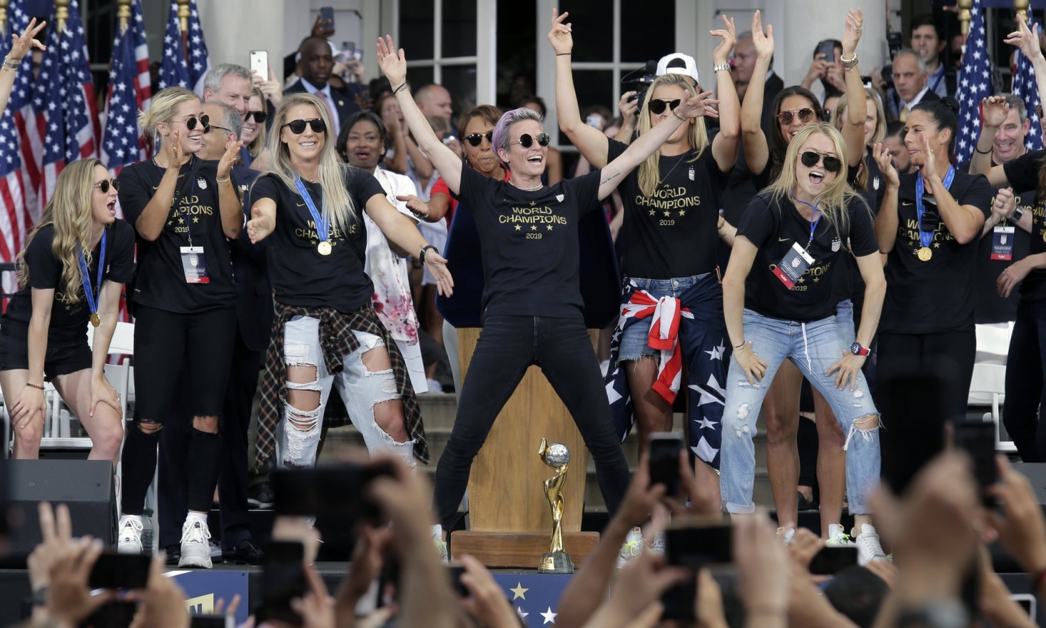 The US women’s soccer team, with Megan Rapinoe, at center, celebrates at City Hall after the ticker tape parade. Photograph: Seth Wenig/AP