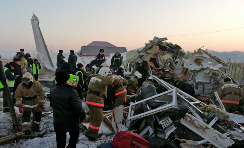 In this handout photo provided by the Emergency Situations Ministry of the Republic of Kazakhstan, police and rescuers work on the side of a plane crash near Almaty International Airport on Dec. 27, 2019. AP