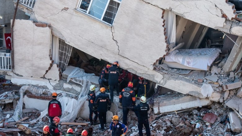 Emergency staff work at the scene of a collapsed building on Sunday in Elazig, Turkey, two days after a 6.8-magnitude earthquake struck. (Burak Kara/Getty Images)