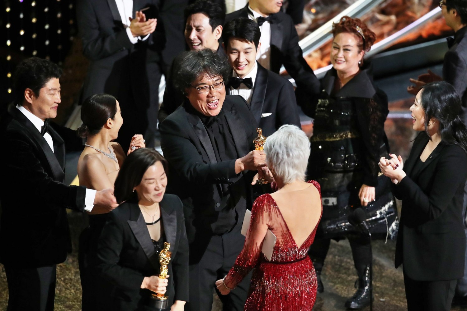 The producer Kwak Sin Ae and director Bong Joon Ho with their Oscars for best picture for “Parasite.”Credit...Noel West for The New York Times