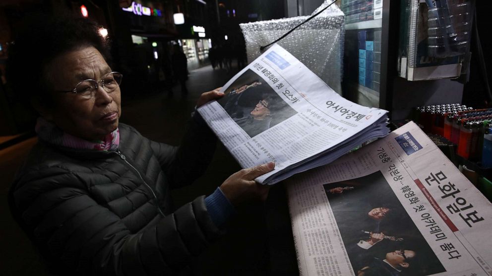 A newsstand vender collects newspapers reporting the South Korean director Bong Joon-ho on February 10, 2020 in Seoul, South Korea. Bong Joon-ho's "Parasite" became the first non-English language film to win best picture.A newsstand vender