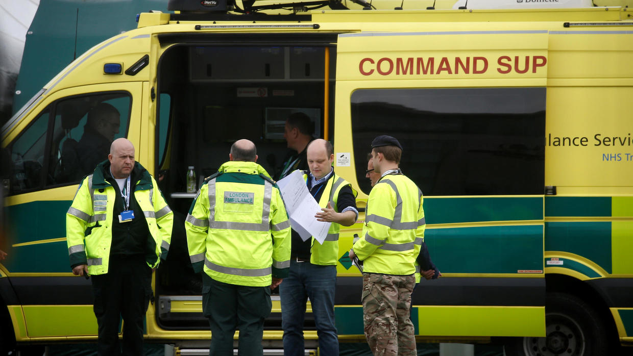Paramedics and military personnel are seen outside the Excel Centre in London, UK on April 1, 2020 while it is being prepared to become the NHS Nightingale Hospital as the spread of COVID-19 continues. REUTERS - HENRY NICHOLLS