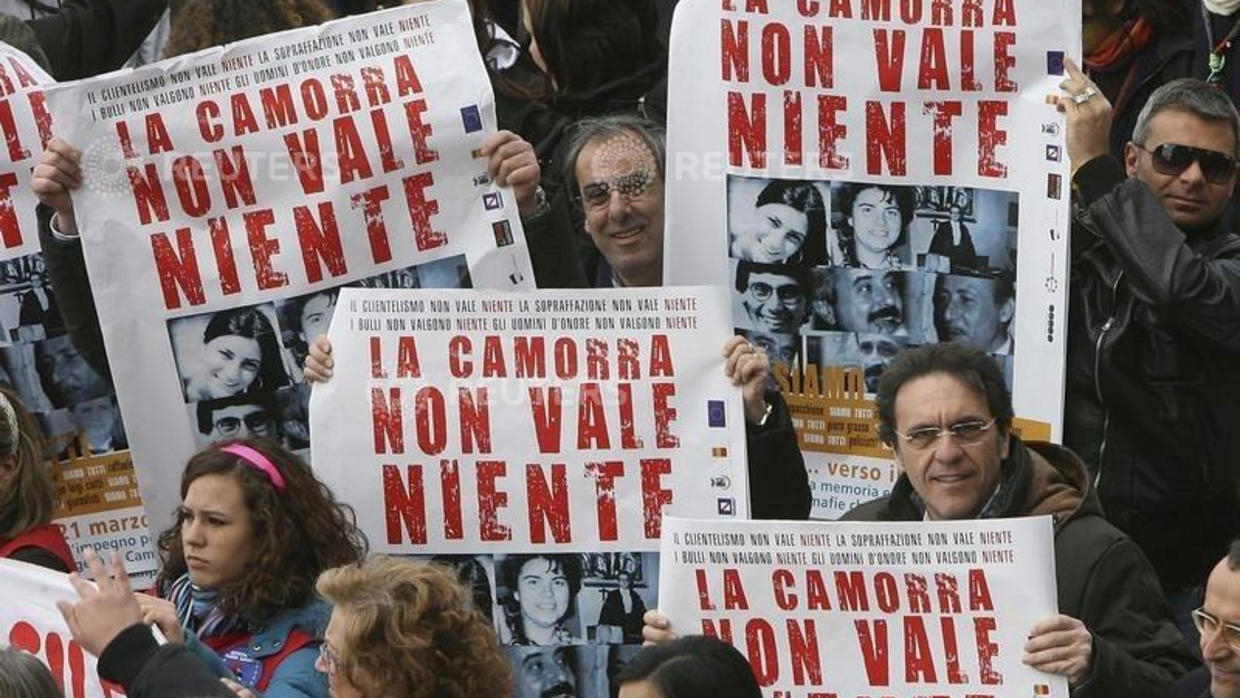 FILE PHOTO: Demonstrators hold banners reading "Camorra worth nothing" as they march in the southern city of Naples March 21, 2009. Reuters - Ciro De Luca