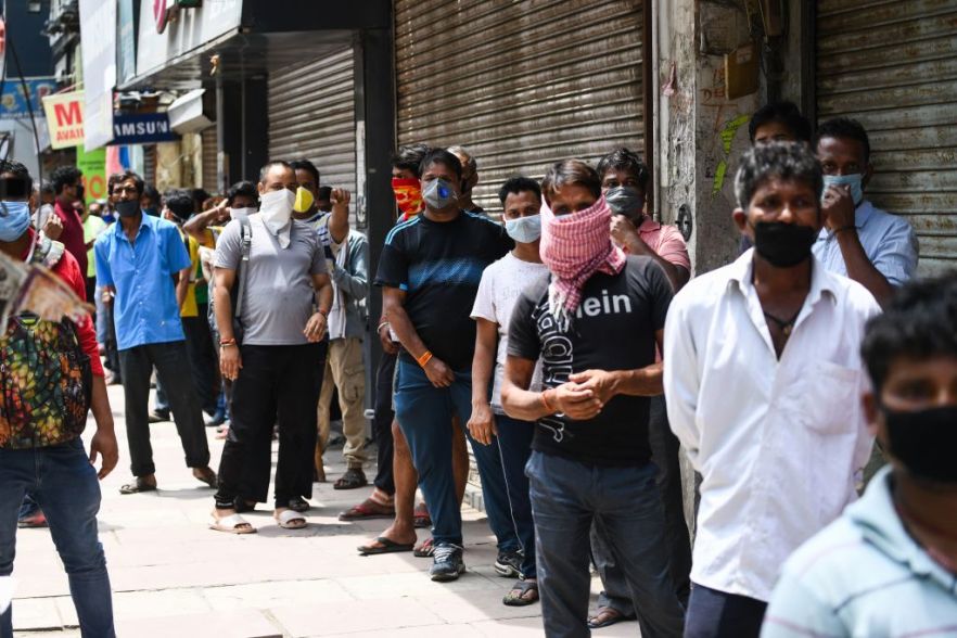 People line up to buy alcohol outside a liquor store after the government eased a nationwide lockdown in New Delhi, India, on May 4, 2020