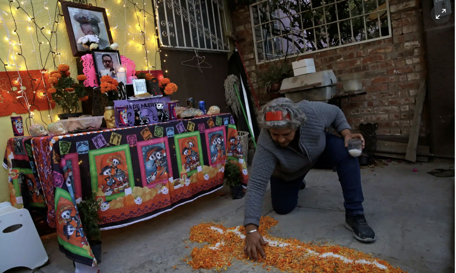 The mother of Andrés García González, a nurse who died of Covid-19, makes an altar to honor her son ahead of the Day of the Dead, in Ciudad Juárez, Mexico. Photograph: José Luis González/Reuters