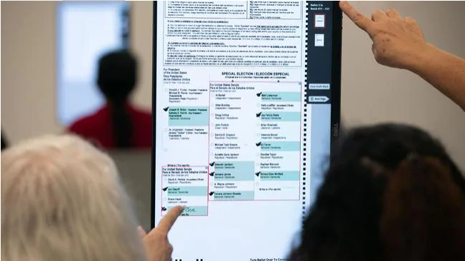 Members of the Gwinnett County adjudication review panel look over remaining scanned ballots at the Gwinnett Voter Registrations and Elections office on November 8, 2020 in Lawrenceville, Georgia. Picture: Jessica McGowan/Getty Images/A