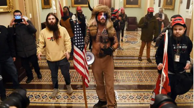 Jake Angeli, a regular at Trump rallies and anti-Biden protests, dressed up with his Davy Crockett hat and showing his Trump wall tattoos. Picture: Saul Loeb/AFPSource:AFP