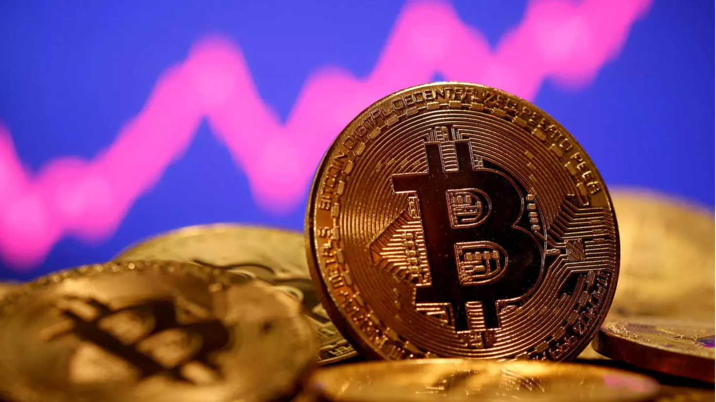 A representation of virtual currency bitcoin is seen in front of a stock graph in this illustration taken January 8, 2021. © Reuters - Dado Ruvic