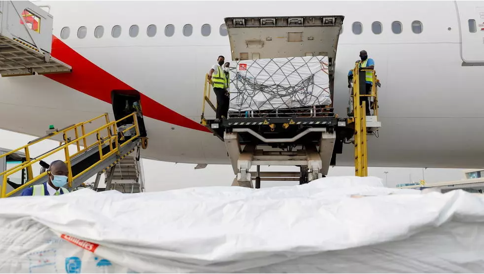 Workers offload boxes of Oxford-AstraZeneca vaccines as the country receives its first batch of Covid-19 jabs under the COVAX scheme, at the international airport of Accra, Ghana February 24, 2021. REUTERS - FRANCIS KOKOROKO