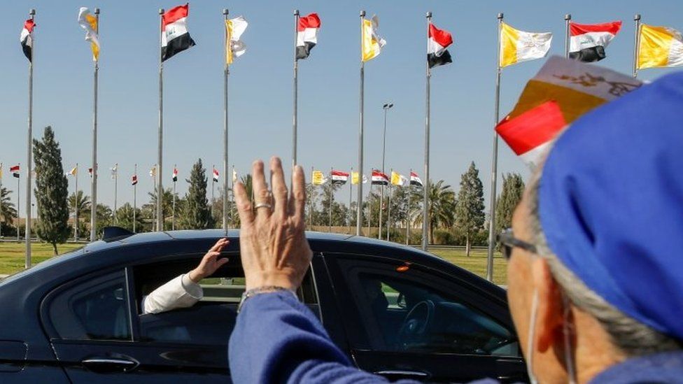 REUTERS / Pope Francis waves as his convoy heads into Baghdad from the airport