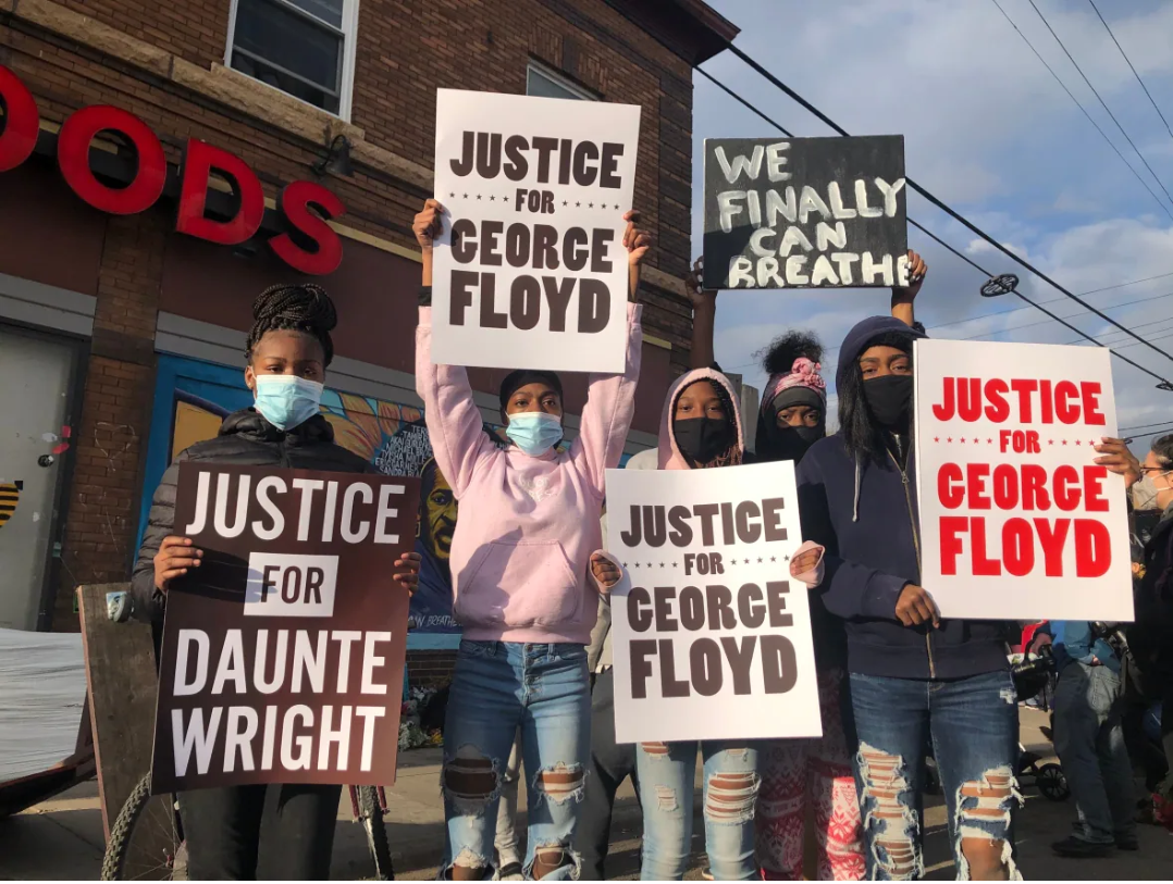People in George Floyd Square in Minneapolis hold signs calling for justice for Floyd and Daunte Wright, who were killed in separate encounters with police. / (Carly Thomas/CBC)
