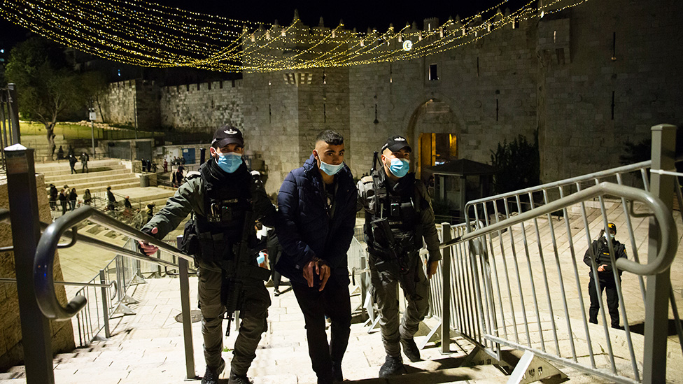 GETTY IMAGES / Israeli police officers detain a young Palestinian man at the Damascus Gate