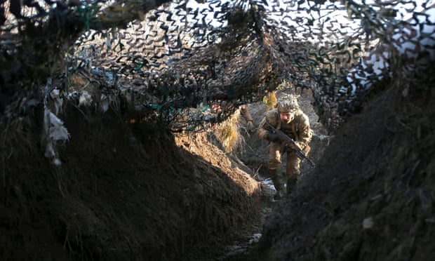 A member of the Ukrainian territorial defense forces walks in a trench on the frontline with Russia-backed separatists near Avdiivka, Donetsk, on Saturday. Photograph: AFP/Getty Images
