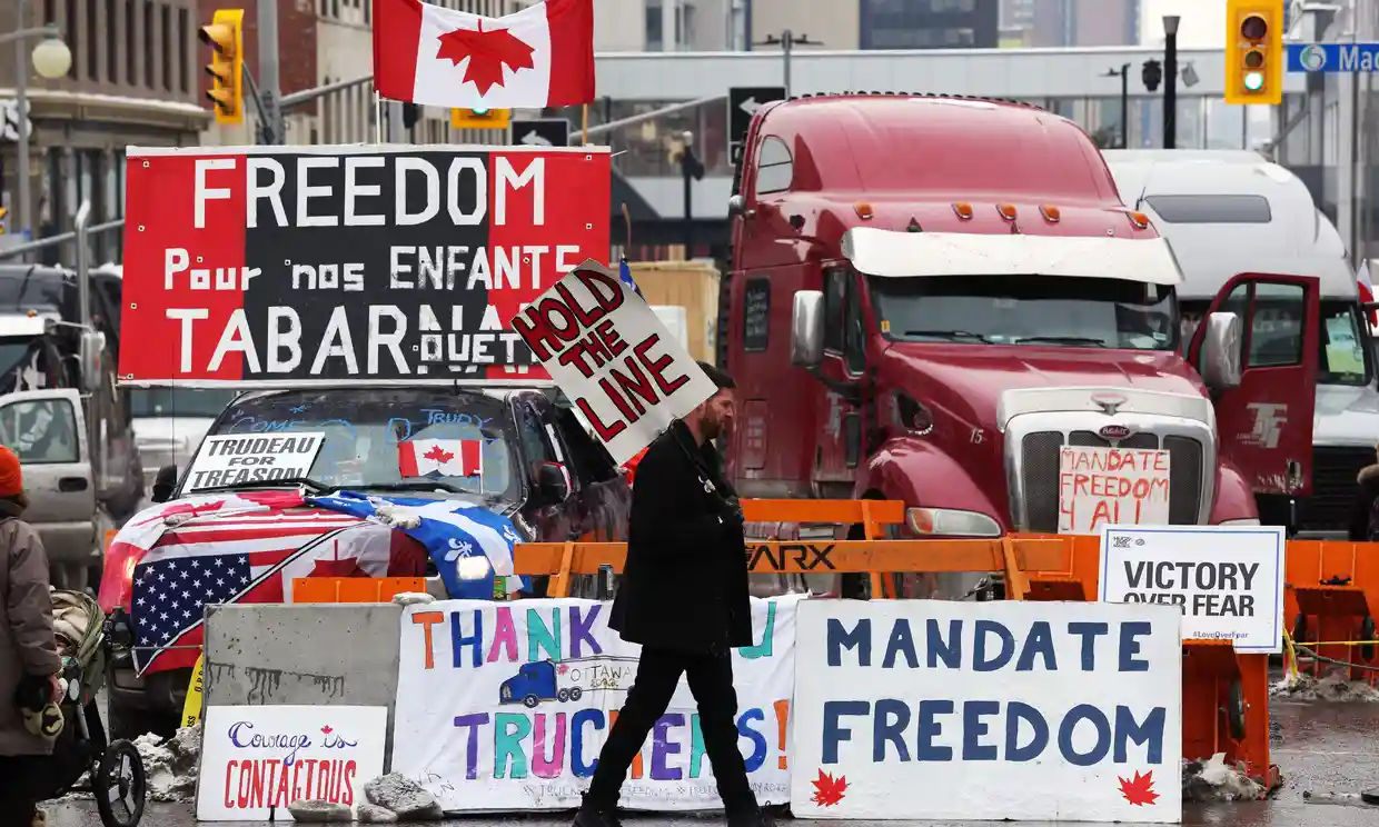 A protester walks in front of parked trucks in Ottawa, the Canadian capital. Photograph: Dave Chan/AFP/Getty Images