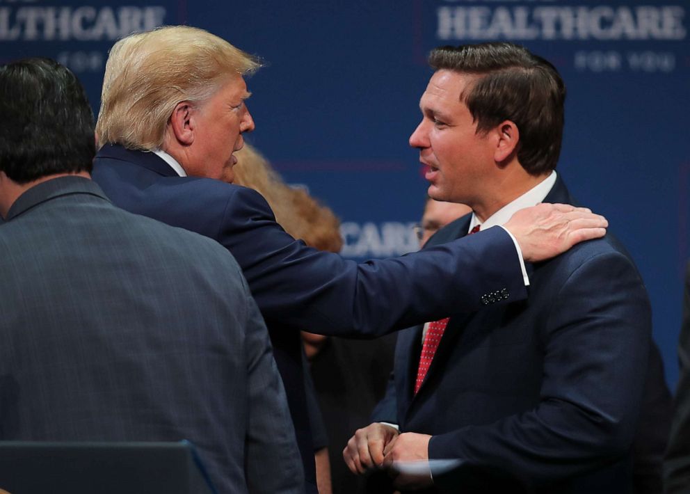 Joe Raedle/Getty Images, FILE President Donald Trump speaks with Florida Gov. Ron DeSantis during an event at the Sharon L. Morse Performing Arts Center on Oct. 03, 2019, in The Villages, Florida.