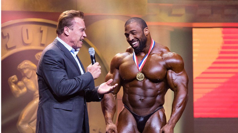 GETTY IMAGES| Cedric McMillan and Arnold Schwarzenegger in 2017