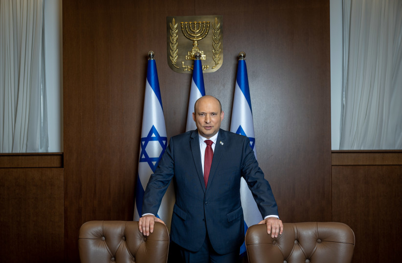 Israeli Prime Minister Naftali Bennett poses for a picture at the Prime Minister's office in Jerusalem, January 26, 2022. (photo credit: YONATAN SINDEL/FLASH90)