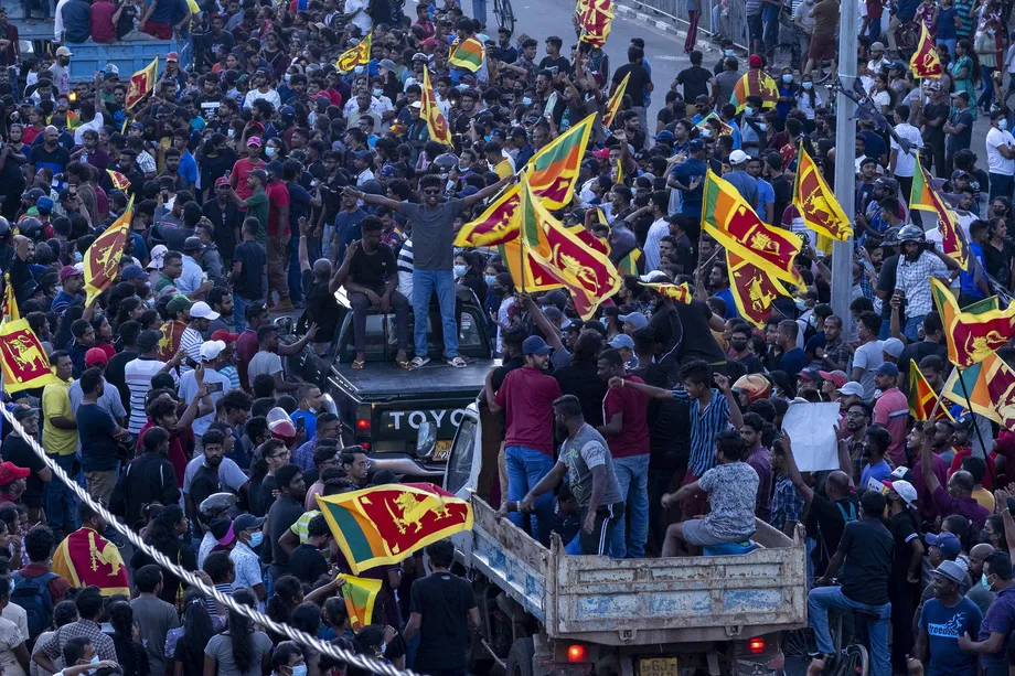 Protesters hold the country flag on Saturday in Galle, Sri Lanka. Buddhika Weerasinghe/Getty Images
