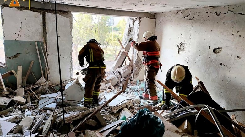 First responders work in a damaged residential building in the Odesa region of Ukraine early Friday, following Russian missile attacks. (Ukrainian Emergency Service/The Associated Press)