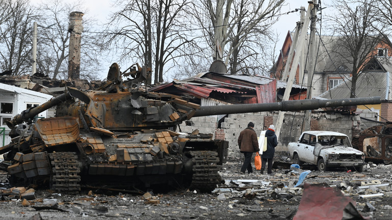 FILE PHOTO: Local residents pass by the destroyed tank of the Ukrainian armed forces in the city of Volnovakha in Donetsk People's Republic. © Sputnik / Maksim Blinov
