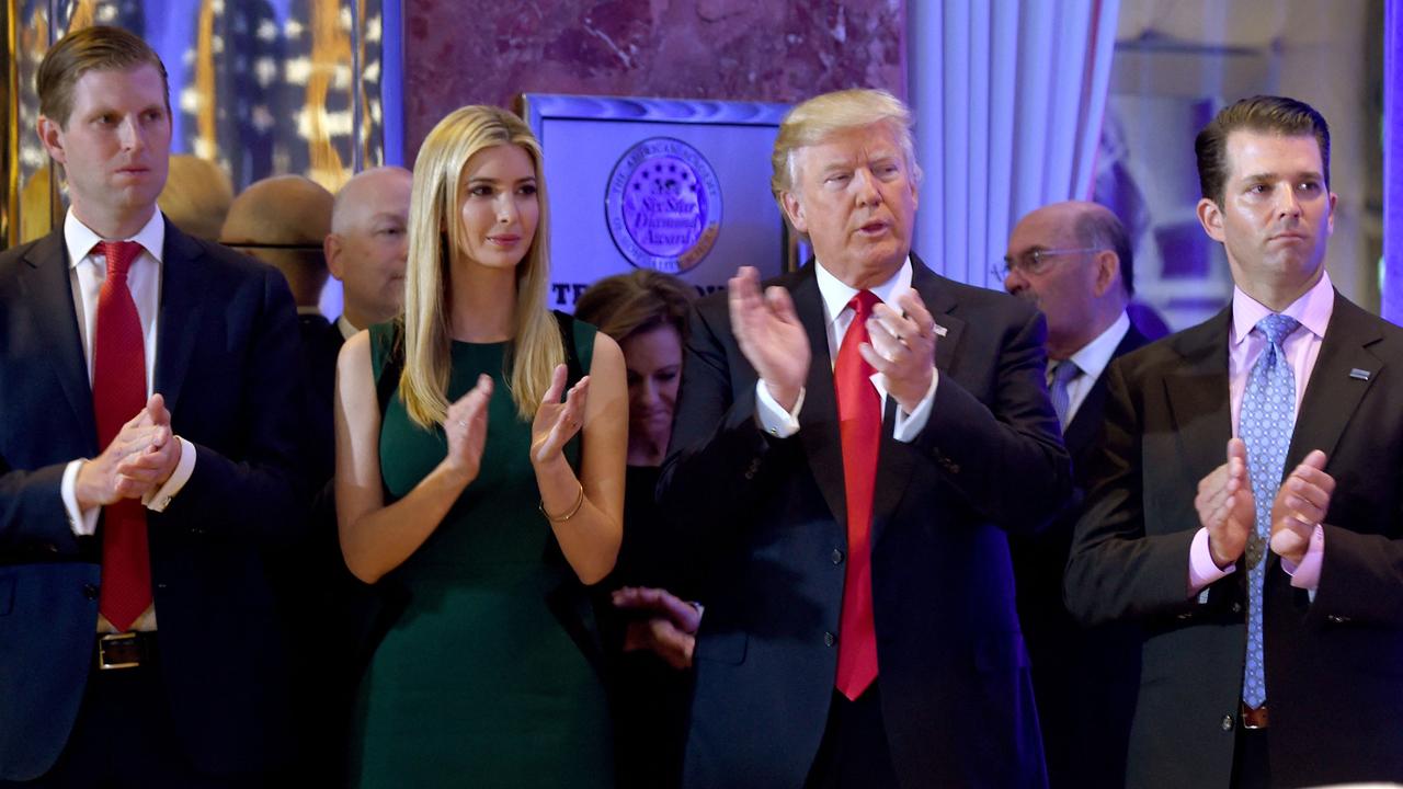 Then President-elect Donald Trump along with his children Eric (L), Ivanka and Donald Jr. in 2017. All have now been named in a lawsuit from New York State (Photo by Timothy A. CLARY / AFP)