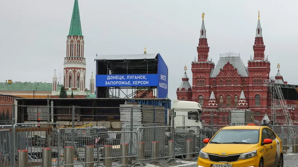 REUTERS / A stand has been erected at Red Square before the speech displaying the names of the regions to be annexed