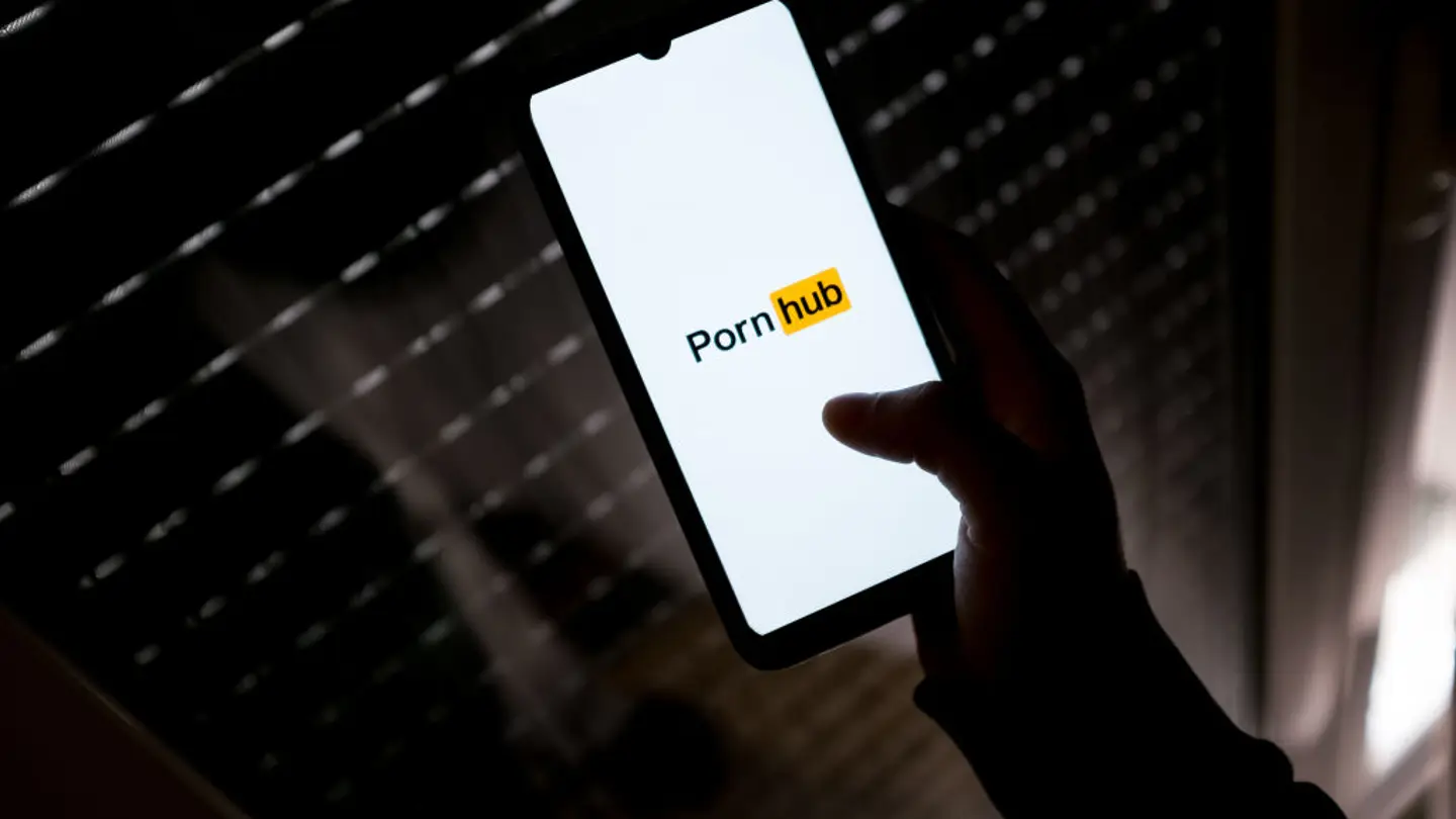 In this photo illustration a PornHub logo seen displayed on a smartphone screen in Athens, Greece on March 16, 2022. ( Photo by Nikolas Kokovlis/NurPhoto via Getty Images)