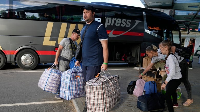 A family from Mariupol arrives from Russia in Narva, Estonia, June 16, 2022, more than a month after they left their hometown. (The Associated Press)