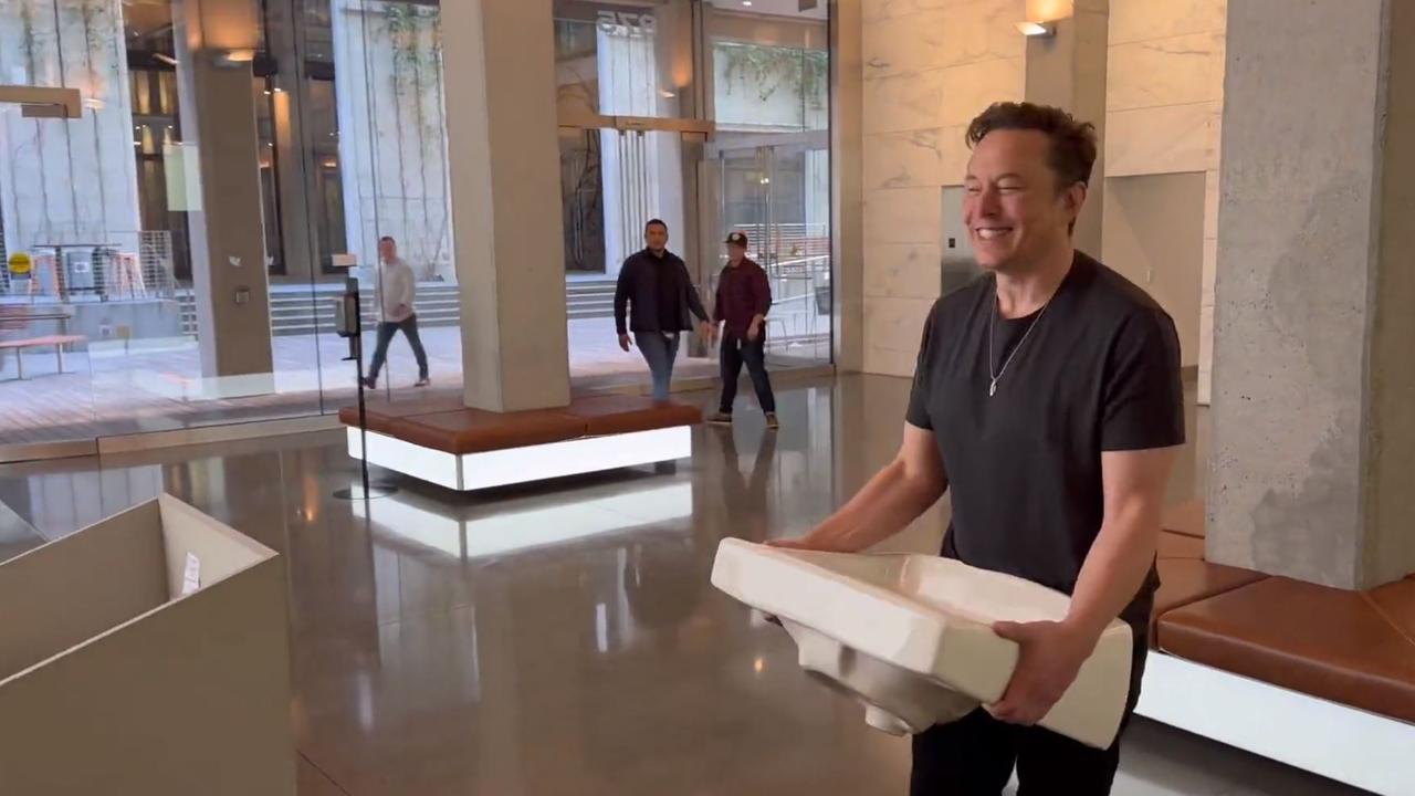 Elon Musk walks into Twitter HQ carrying a sink