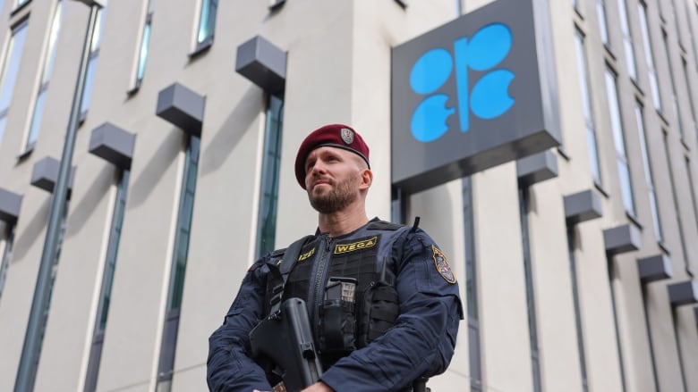 An armed police officer patrols outside the OPEC Secretariat building in Vienna, where members of the oil alliance are meeting in person for the first time since the pandemic began. (Akos Stiller/Bloomberg)