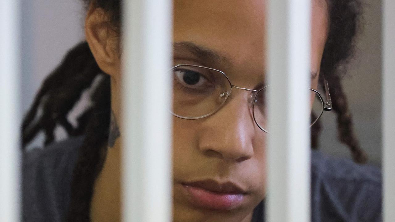Brittney Griner is seen behind bars (Photo by EVGENIA NOVOZHENINA / POOL / AFP)