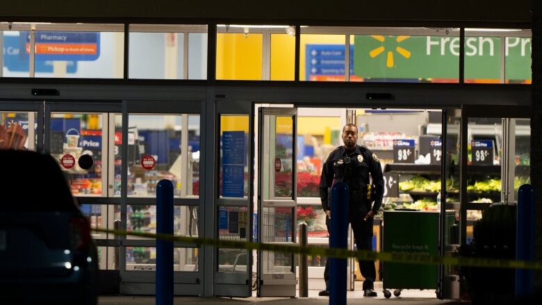 A law enforcement officer guards an entrance at a Walmart in Chesapeake, Va., early Wednesday. (Alex Brandon/The Associated Press)