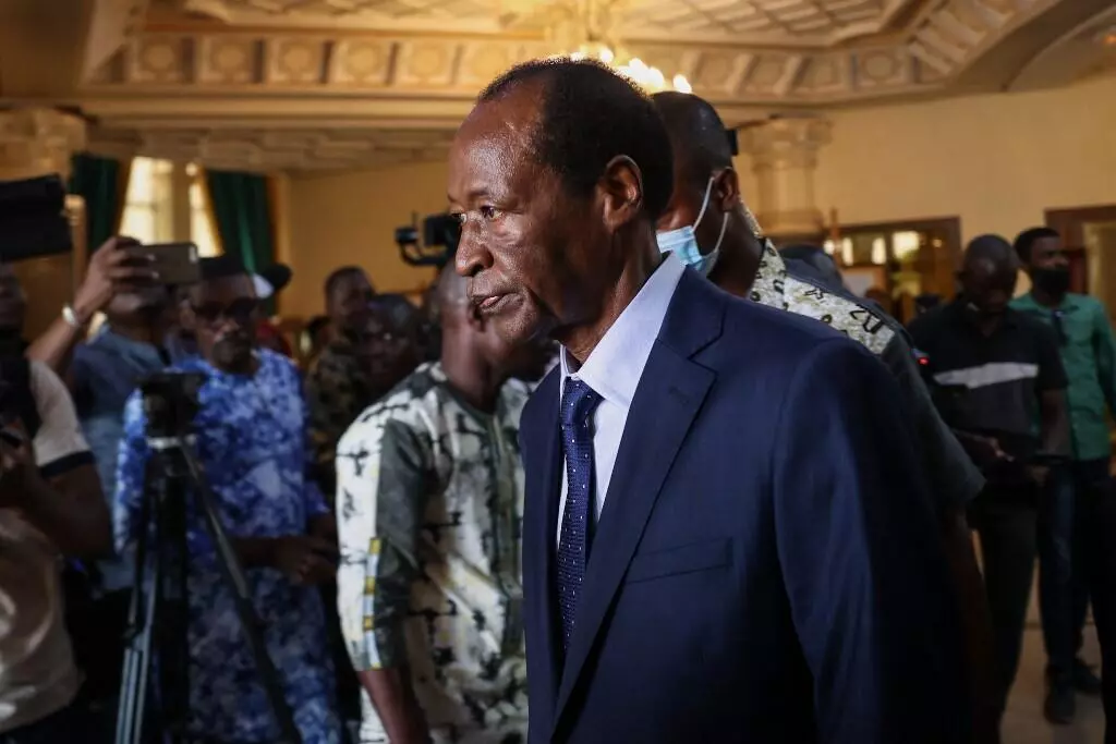 Former Burkina Faso President Blaise Compaore (C) leaves the presidential palace in Ouagadougou on July 8, 2022. © Olympia de Maismont, AFP