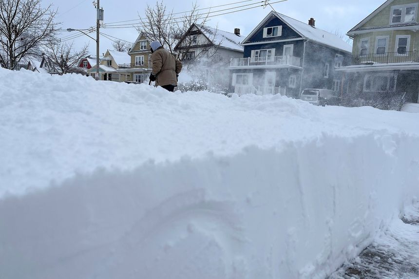 Clearing snow was a tall task on Christmas Day in Buffalo, N.Y. PHOTO: BRIDGET HASLINGER/ASSOCIATED PRESS