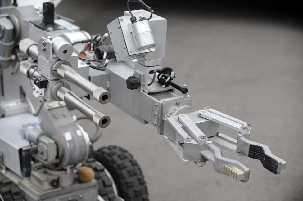 GETTY IMAGES /  A bomb disposal robot extends its arm