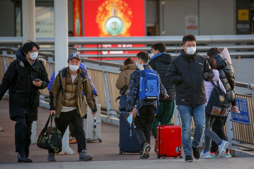 Travelers at Beijing’s international airport on Sunday. PHOTO: MARK R CRISTINO/SHUTTERSTOCK