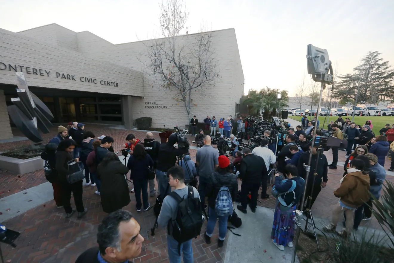 Media wait outside the Civic Center in Monterey Park, Calif., Sunday, Jan. 22, 2023. At least 10 people were killed and 10 others wounded in a shooting rampage at the Star Ballroom Dance Studio after a Lunar New Year celebration on Saturday, Jan. 21, 2023