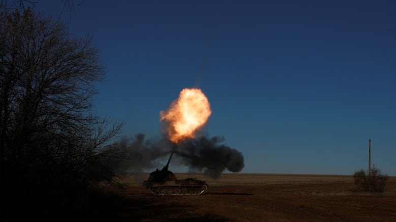 A Ukrainian army artillery brigade fires a howitzer near Soledar, Ukraine, on Jan. 11. (Clodagh Kilcoyne/Reuters)