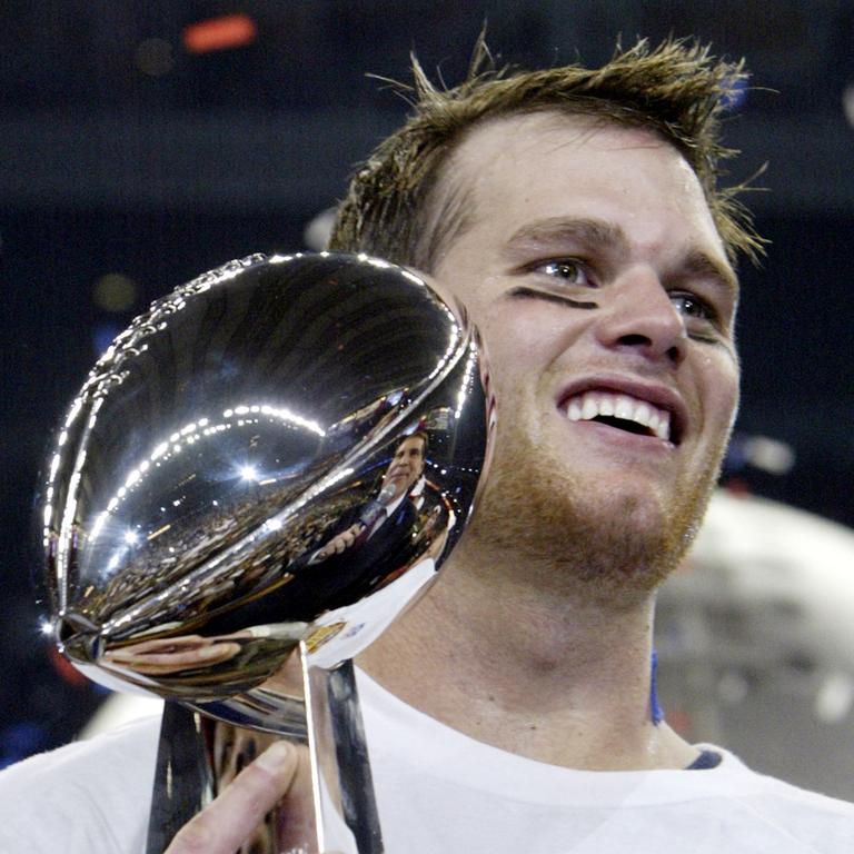 Quarterback Tom Brady of the New England Patriots holds the Vince Lombardi trophy after winning Super Bowl XXXVIII. (Photo by JEFF HAYNES / AFP)