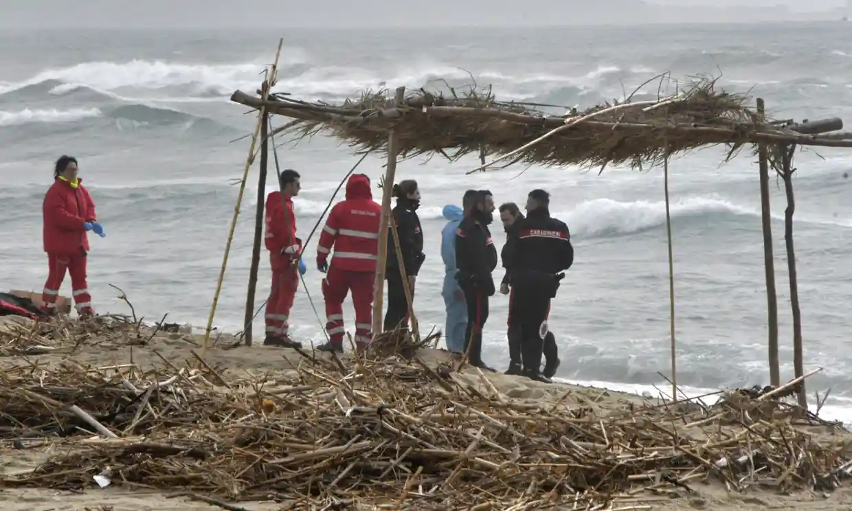 Carabinieri officers and Red Cross personnel at a beach near Cutro, southern Italy, on Sunday. Photograph: Giuseppe Pipita/EPA