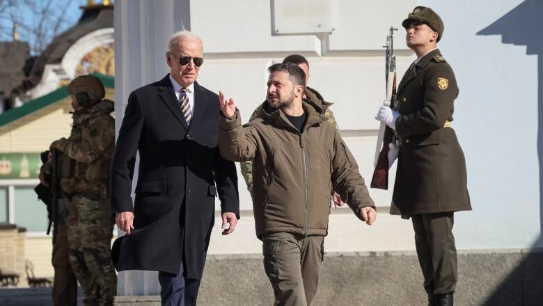 U.S. President Joe Biden and Ukraine's President Volodymyr Zelenskyy walk next to Saint Michael’s cathedral in Kyiv on Monday. (Gleb Garanich/Reuters)