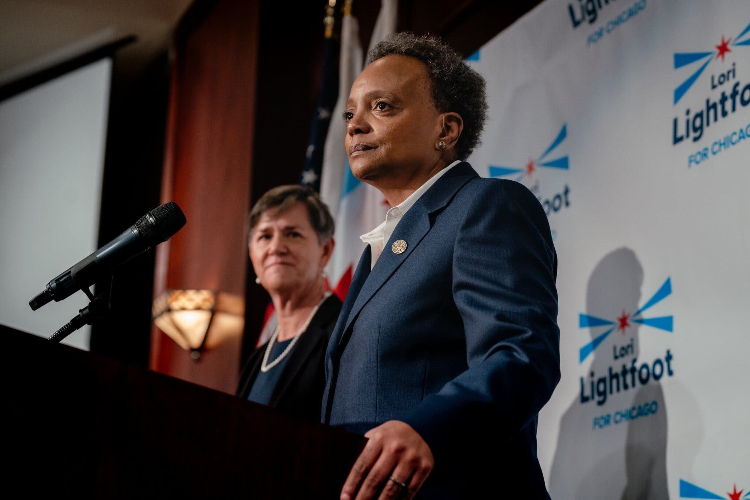 Mayor Lori Lightfoot stood next to her wife, Amy Eshleman, as she conceded the race to her opponents on Tuesday night.Credit...Jamie Kelter Davis for The New York Times