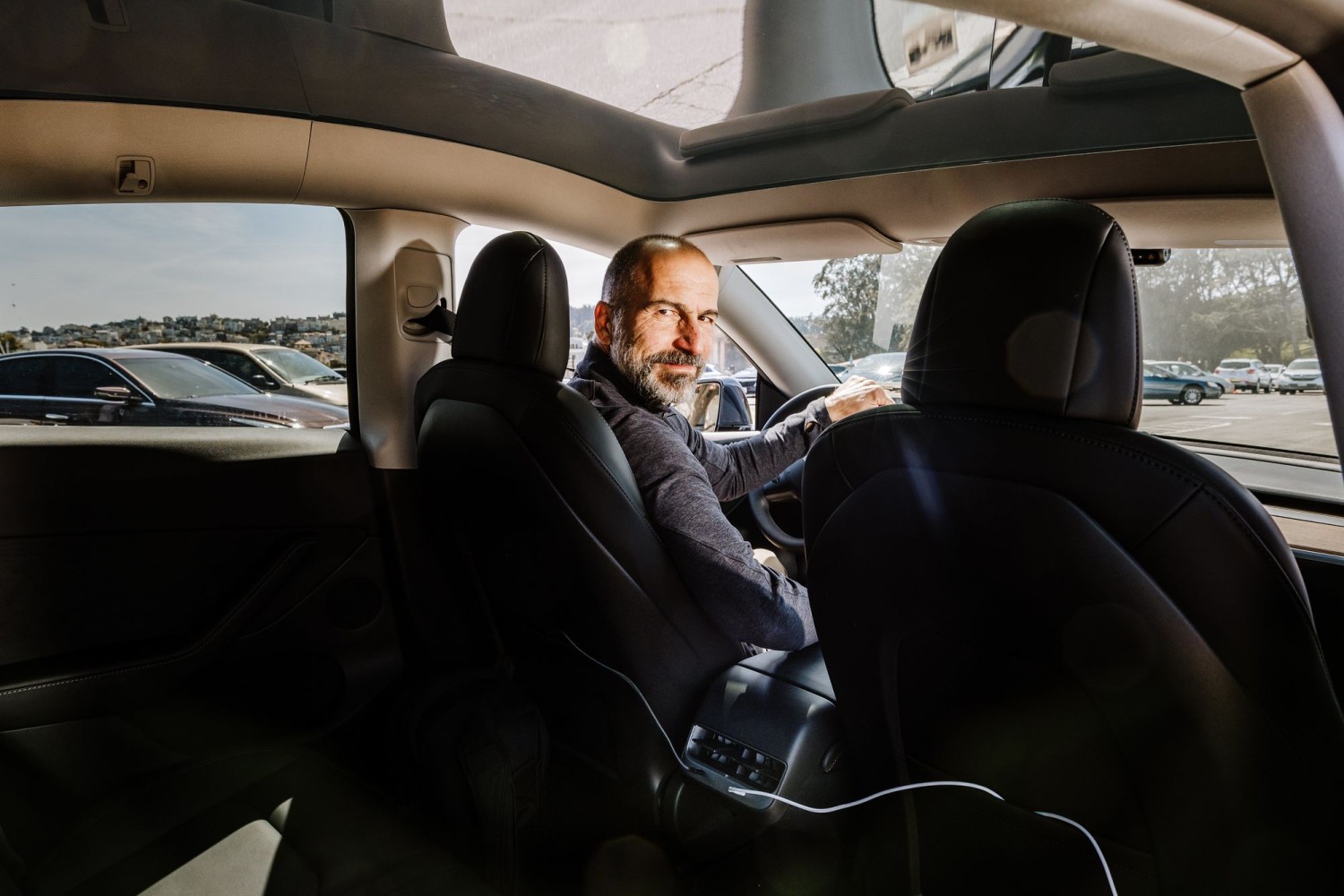 CEO Dara Khosrowshahi in the gray Tesla he uses to drive passengers, in San Francisco on Wednesday.