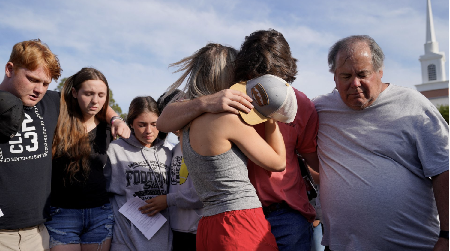 [1/5] Community members embrace each other during a vigil the day after a shooting during a teenager's birthday party at Mahogany Masterpiece Dance Studio in Dadeville, Alabama, U.S., April 16, 2023. REUTERS/Cheney Orr