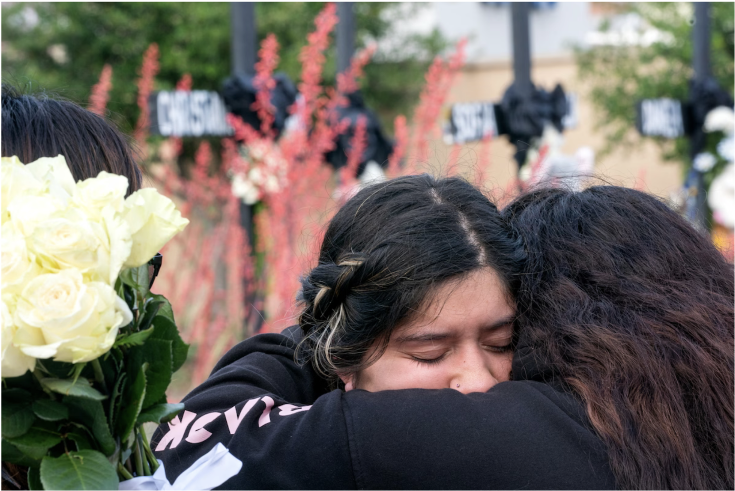 Marisella Mendoza, whose friend Christian LaCour was killed in the Allen, Texas shooting on Saturday, is comforted at a makeshift memorial outside the Allen Premium Outlets on Monday. (Jeffrey McWhorter for The Washington Post)