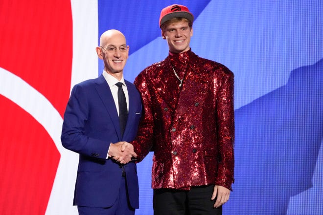 Gradey Dick poses with NBA commissioner Adam Silver after being selected 13th by the Toronto Raptors during the NBA draft.