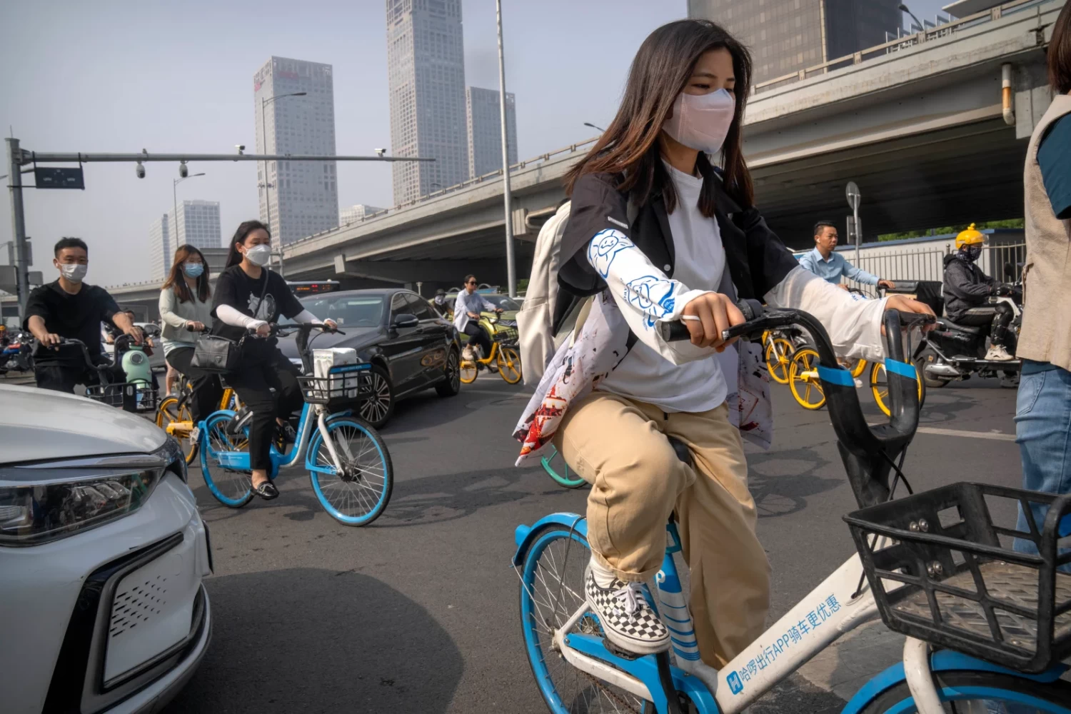Commuters wearing face masks make their way along a street in the central business district during the morning rush hour in Beijing. Mark Schiefelbein—AP Photo