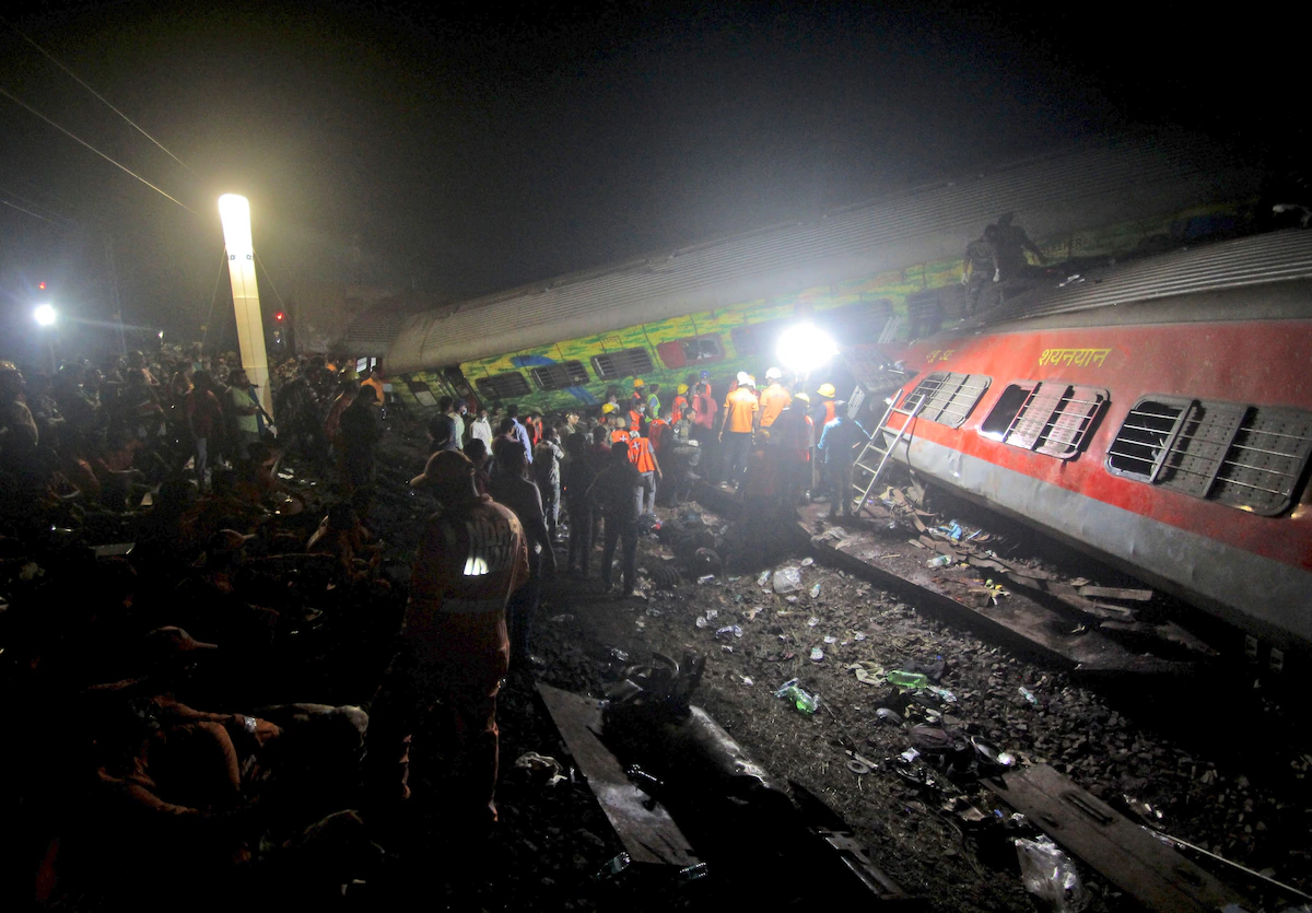 Rescuers work at the site where passenger trains derailed in eastern India on Friday. (AP)